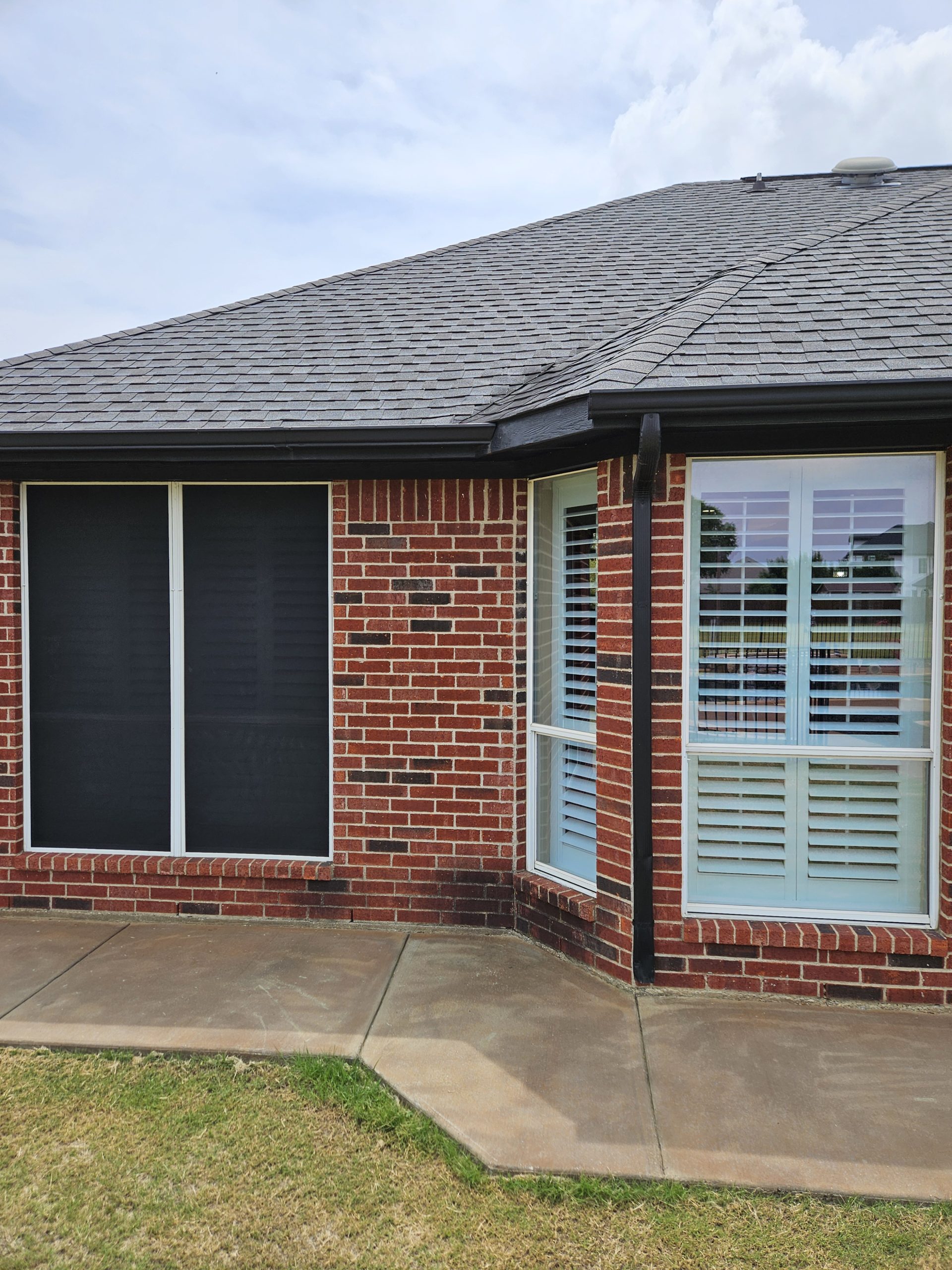 Black Shingle Roof On A Brick Home photo 17