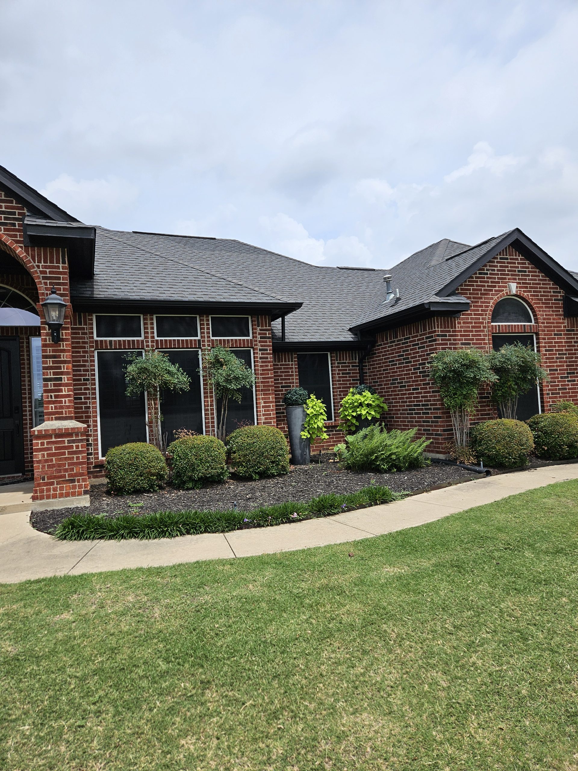 Black Shingle Roof On A Brick Home photo 5