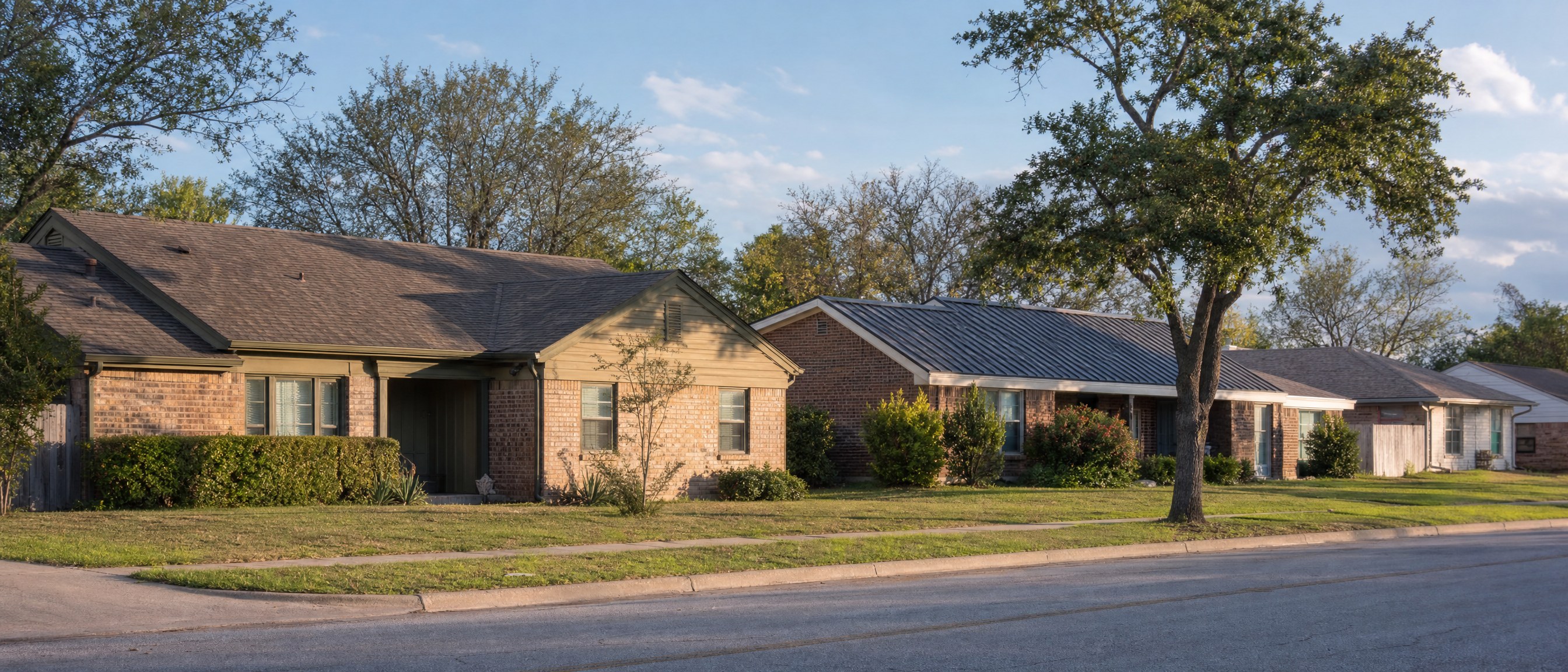 Modest established brick homes along a residential street in Keene, TX