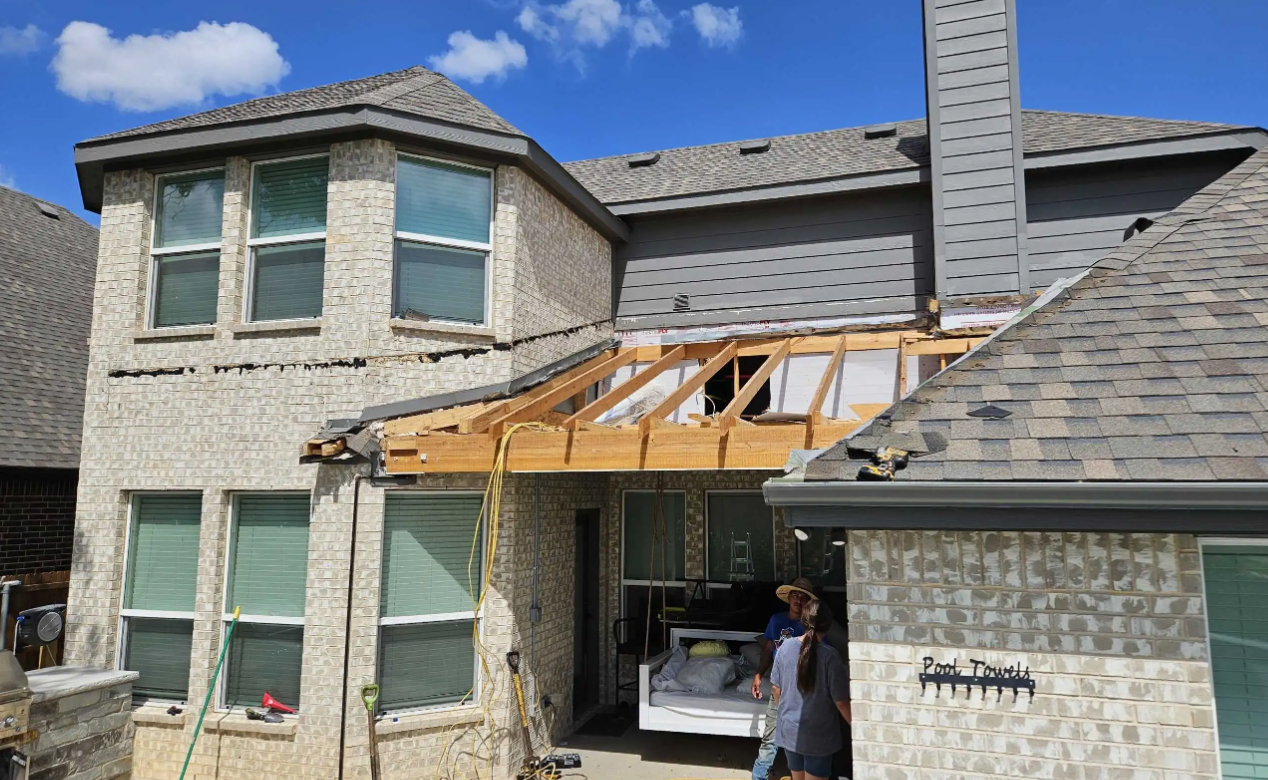 W2 Construction roof replacement in progress showing exposed framing on a Johnson County home