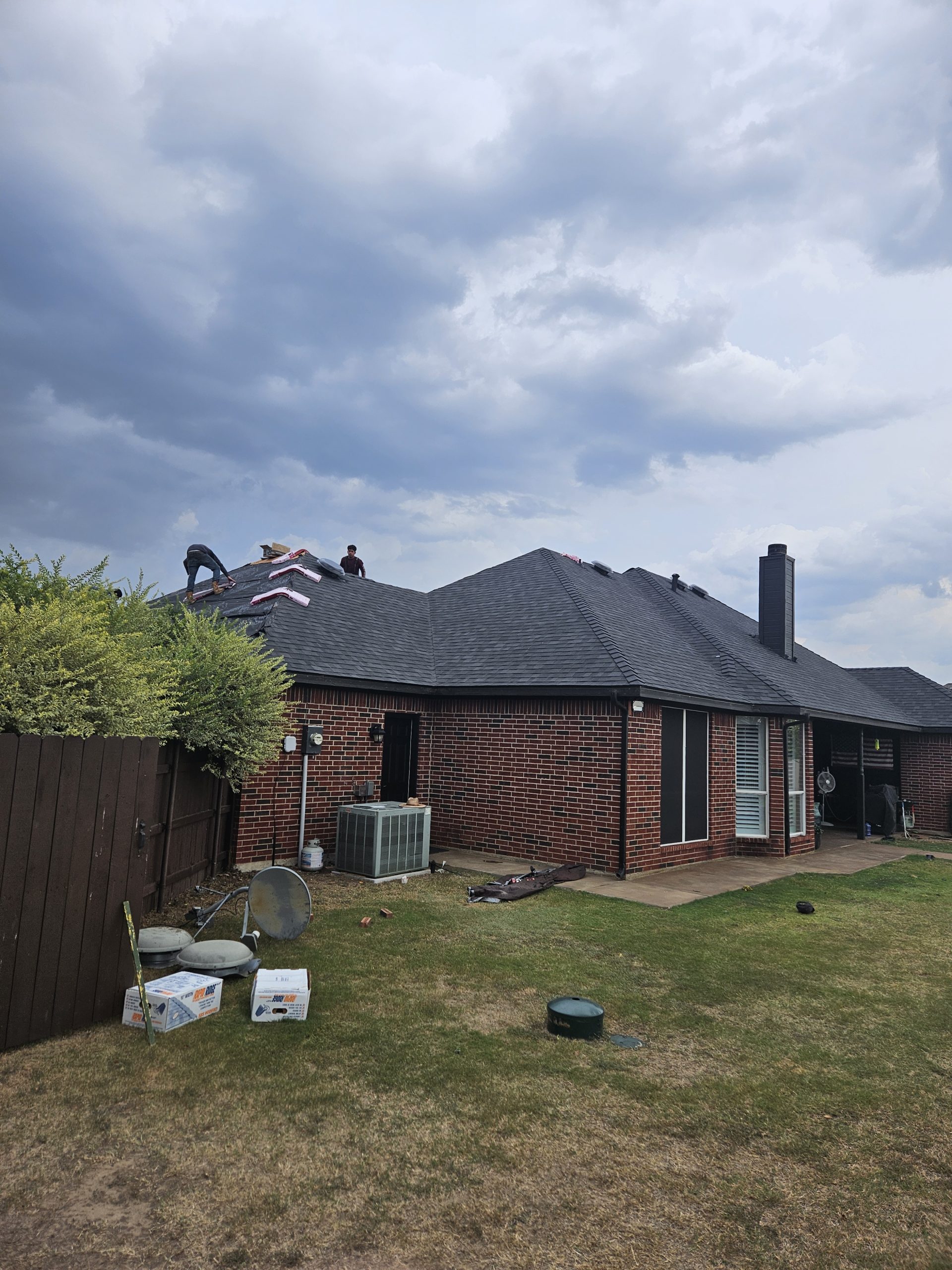 Black Shingle Roof On A Brick Home photo 3