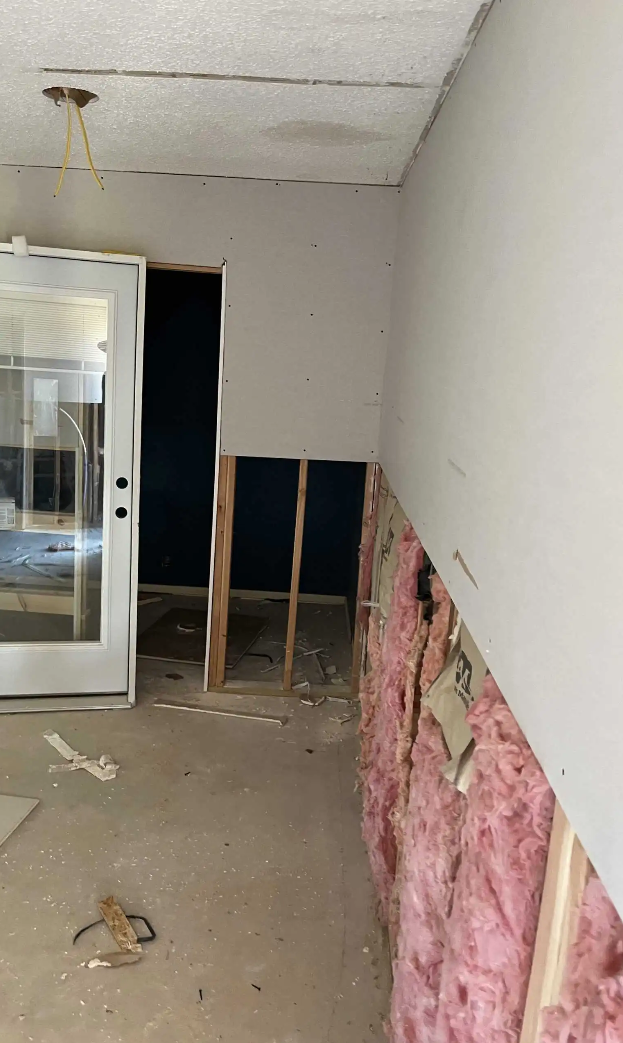 W2 Construction insulation upgrade showing exposed wall insulation and new drywall in a Johnson County home