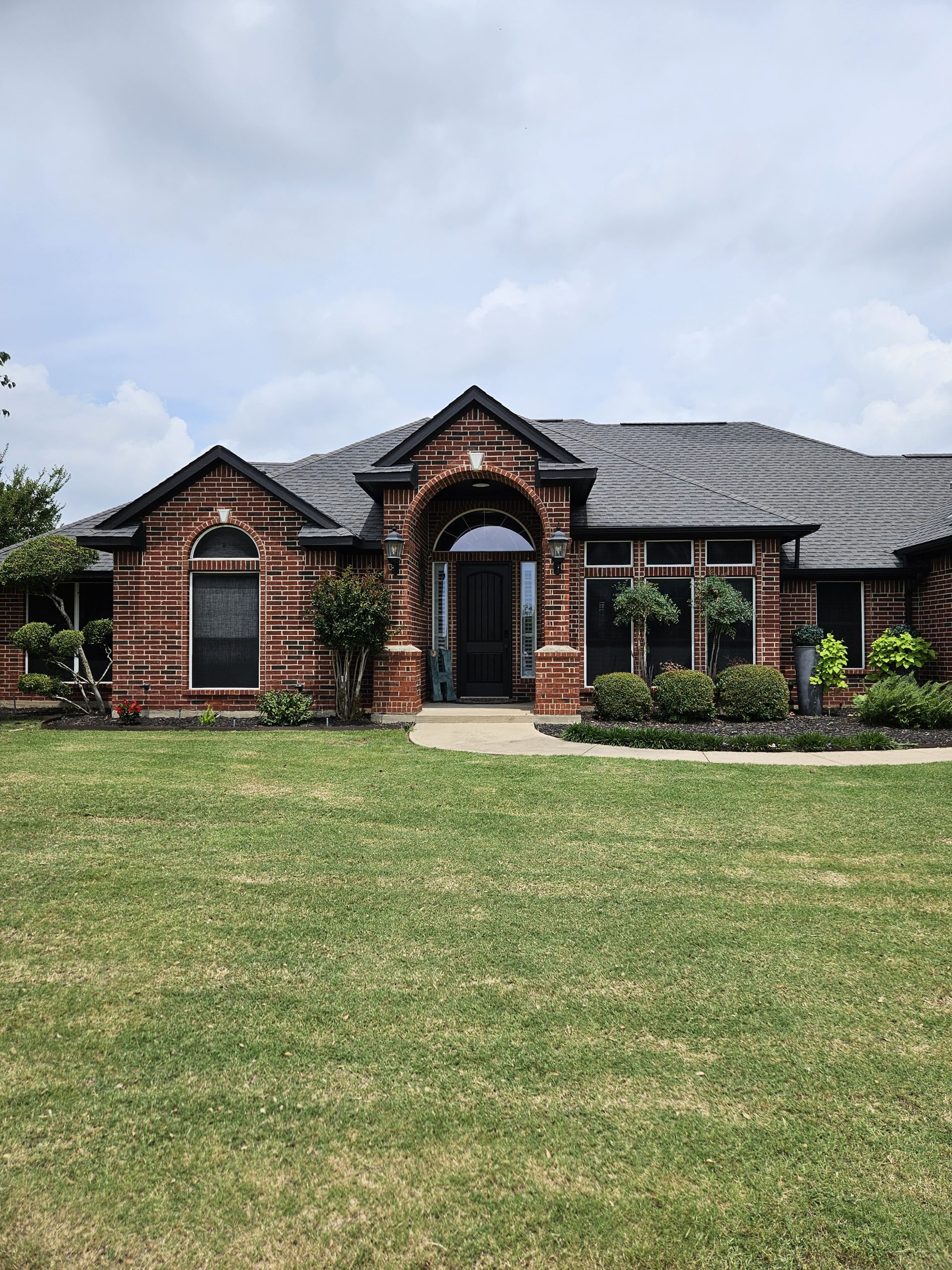 Black Shingle Roof On A Brick Home photo 4