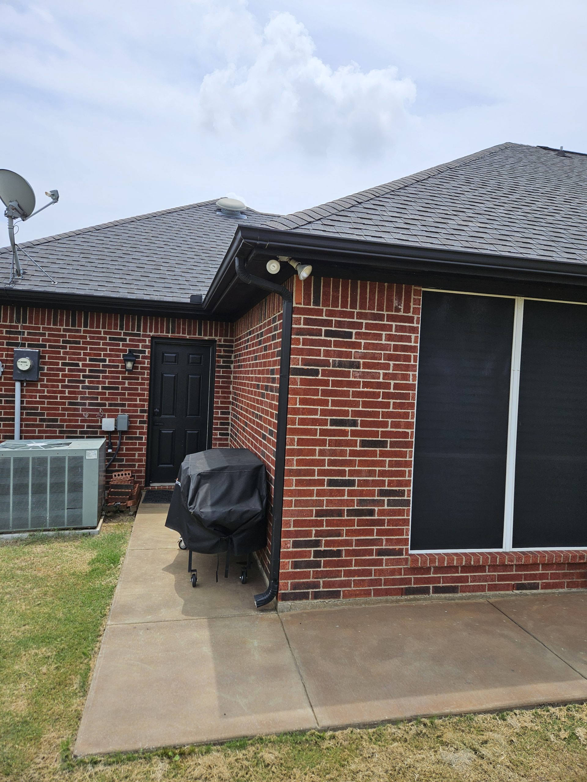 Black Shingle Roof On A Brick Home photo 19