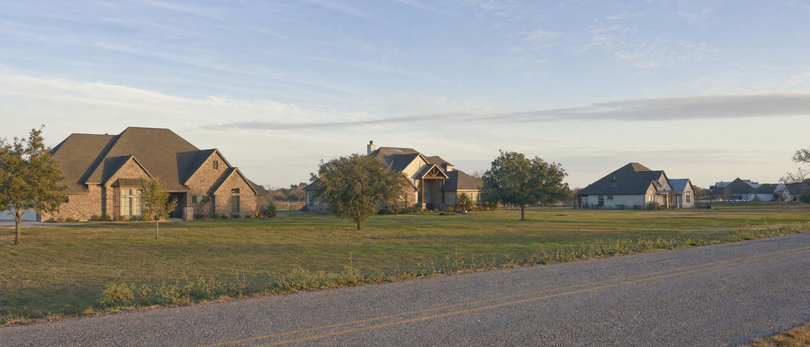 Scattered homes and open land viewed from a farm road in Johnson County, TX