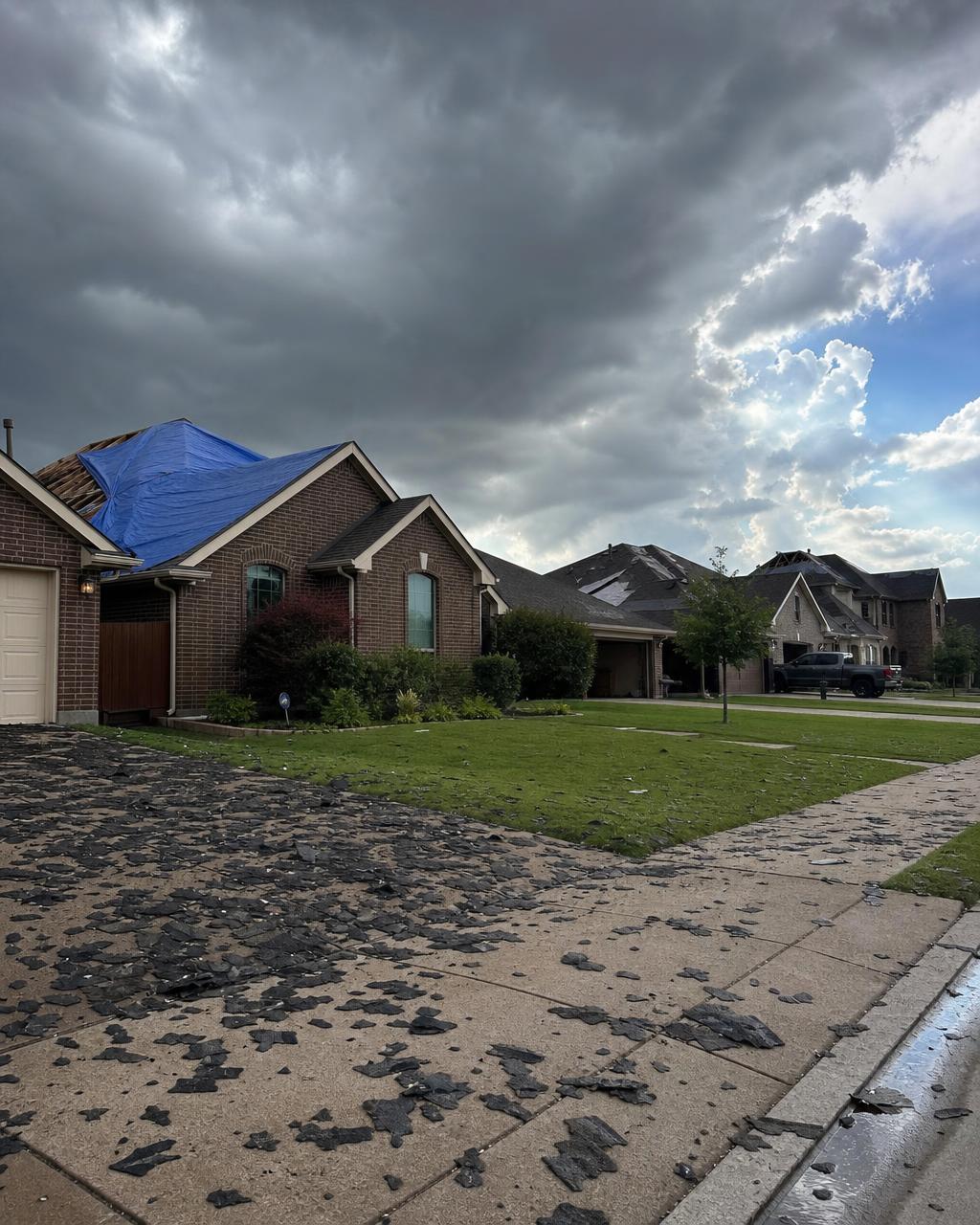 Storm damaged roofs and shingle debris in a Johnson County, TX neighborhood